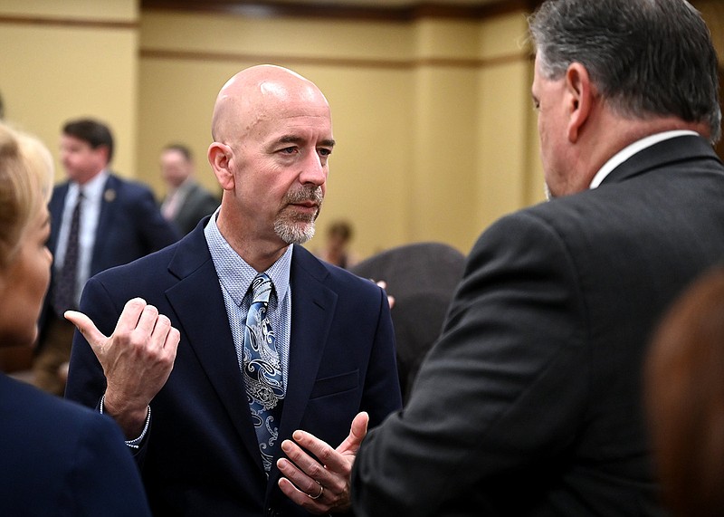 Arkansas Education Secretary Jacob Oliva (left) talks with state Rep. Brian Evans, R-Cabot, before the start of a meeting with the House Education Committee on Thursday, Jan. 12, 2023. (Arkansas Democrat-Gazette/Stephen Swofford)