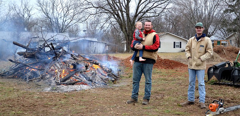 TIMES photograph by Annette Beard
Steve Ferguson, his son, and Jeremy Jordan assisted in burning trees cut down to enlarge the Pea Ridge Cemetery Thursday, Jan. 12, 2023.