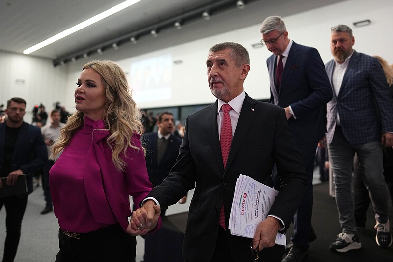 Presidential candidate Andrej Babis accompanied with his wife Monika leaves the stage after addressinng media after the preliminary results for the first round of presidential election in Prague, Czech Republic, Saturday, Jan. 14, 2023. (AP Photo/Petr David Josek)