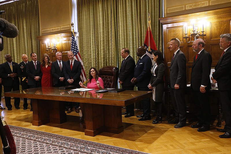 Gov. Sarah Huckabee Sanders signs her first executive orders on Tuesday, Jan. 10, 2023, at the state Capitol in Little Rock. 
More photos at www.arkansasonline.com/111Sanders/
(Arkansas Democrat-Gazette/Thomas Metthe)