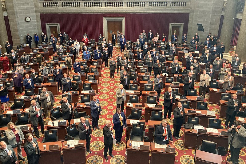 FILE - Members of the Missouri House of Representatives recite the Pledge of Allegiance as they begin their annual legislative session, Jan. 5, 2022, in Jefferson City, Mo. Women who serve in the Missouri House will face a tougher dress code when they return to the floor this week after a debate that Democrats panned as a pointless distraction from the issues facing the state. The new rules require female legislators and staff members to wear a jacket such as a cardigan or blazer. The Republican lawmaker who introduced the change said it was done to ensure decorum and mirror the men’s dress code. Democrats called it ridiculous, saying women should not be policed for their fashion choices. (AP Photo/David A. Lieb, File)