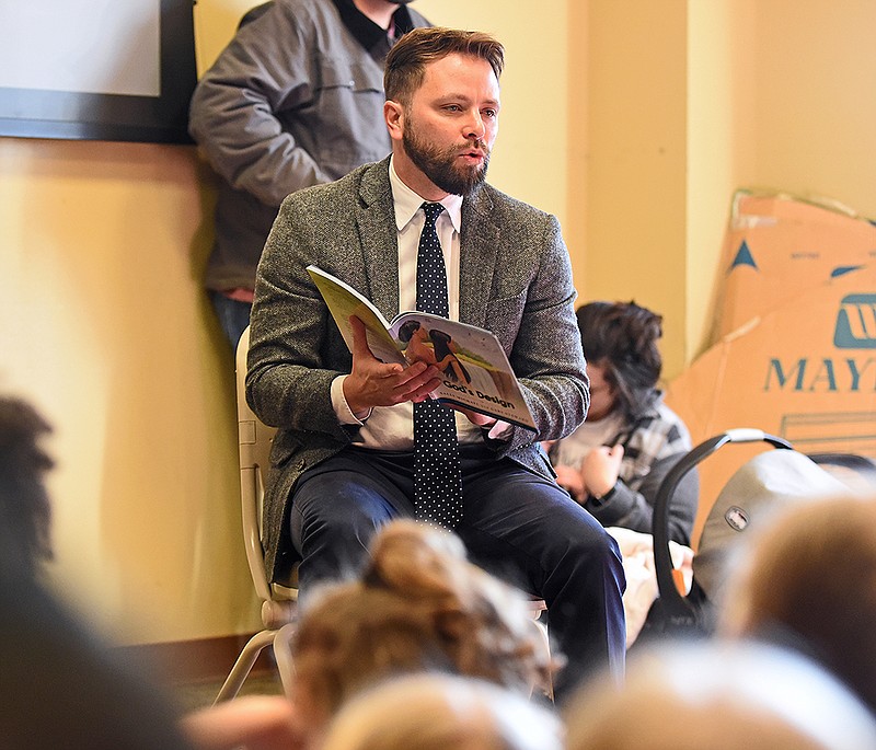 Owen Strachan, provost and research professor of theology at Grace Bible Theological Seminary, reads "God’s Design" by Sally Michael and Gary Steward on Thursday at the Faulkner County Library in Conway.
(Arkansas Democrat-Gazette/Staci Vandagriff)