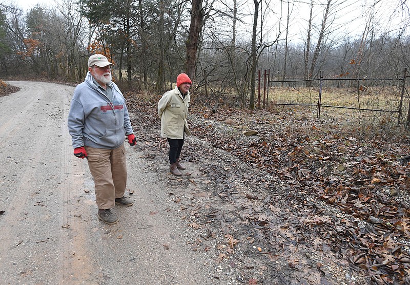Janet Bachman and Jim Luckens show the boundary Thursday, Jan. 12, 2023, of their property along Schaffer Road in Washington County. Bachman and Luckens have protected their 128 acres for the future with a conservation easement through the Northwest Arkansas Land Trust. Visit nwaonline.com/photo for today's photo gallery. 
(NWA Democrat-Gazette/Andy Shupe)