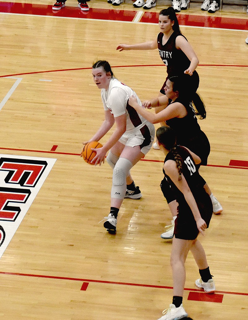 Mark Humphrey/Enterprise-Leader
Farmington sophomore Zoey Bershers passes out of the post after facing a triple team of Gentry defenders. Gentry needed help guarding the 6-feet-3 Farmington center, who dominated 1-on-1 matchups. Bershers scored 16 points as Farmington beat the Lady Pioneers, 56-37, on Friday.