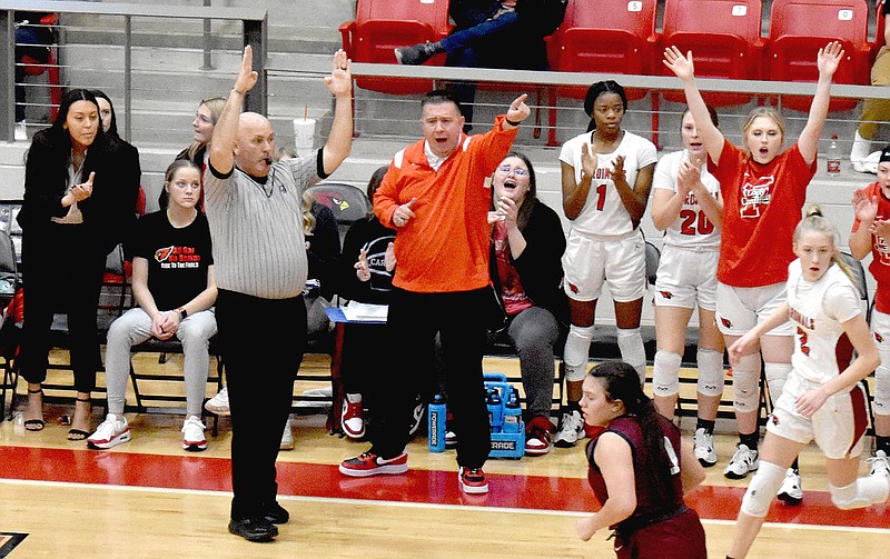 Mark Humphrey/Enterprise-Leader
Farmington head girls basketball coach Brad Johnson celebrates as an official signals a made 3-pointer by the Lady Cardinals during a Jan. 13, 2023, Colors Day 56-37 win over Gentry in 4A-1 Conference action. On Dec. 29, 2022, Johnson achieved the 400th win of his career that includes a couple stints coaching boys in Arkansas high school basketball.