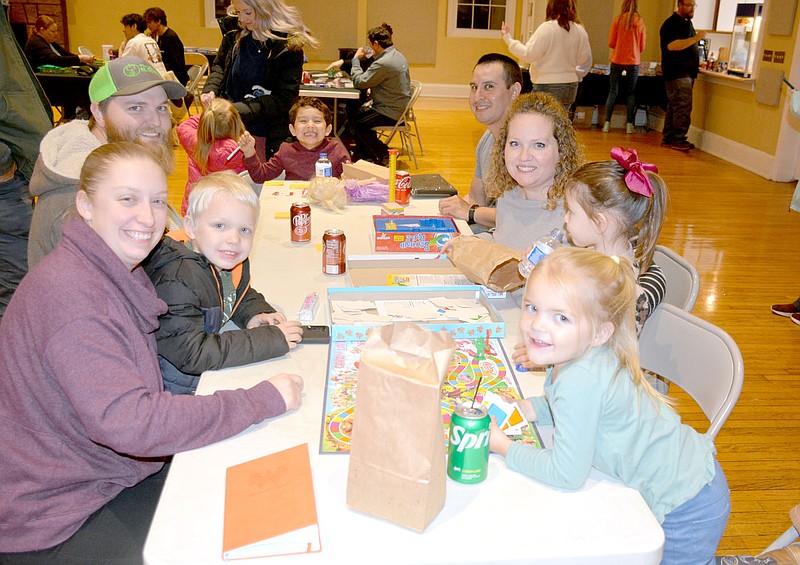 Marc Hayot/Herald-Leader

Maddox Budder (center) smiles for the camera while he poses with friends (left side), Jessica Thurman, Mason Thurman, Travis Thurman, and family (right side) Trent Budder, Elizabeth Budder, Eloise Budder and Kenzie Thurman pose for a photo at Family Game Night on Friday, Jan. 13, at the Siloam Springs Community Building.