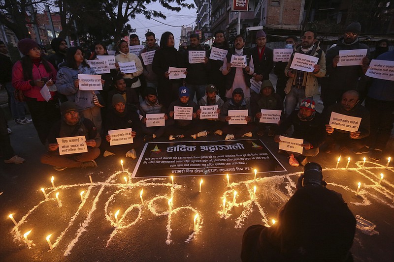 People observe a candlelight vigil in memory of victims of a plane crash Monday, Jan. 16, 2023, in Kathmandu, Nepal. Nepal began a national day of mourning Monday as rescue workers resumed the search for six missing people a day after a plane to a tourist town crashed into a gorge while attempting to land at a newly opened airport, killing at least 66 of the 72 people aboard in the country's deadliest airplane accident in three decades. (AP Photo/Bikram Rai)