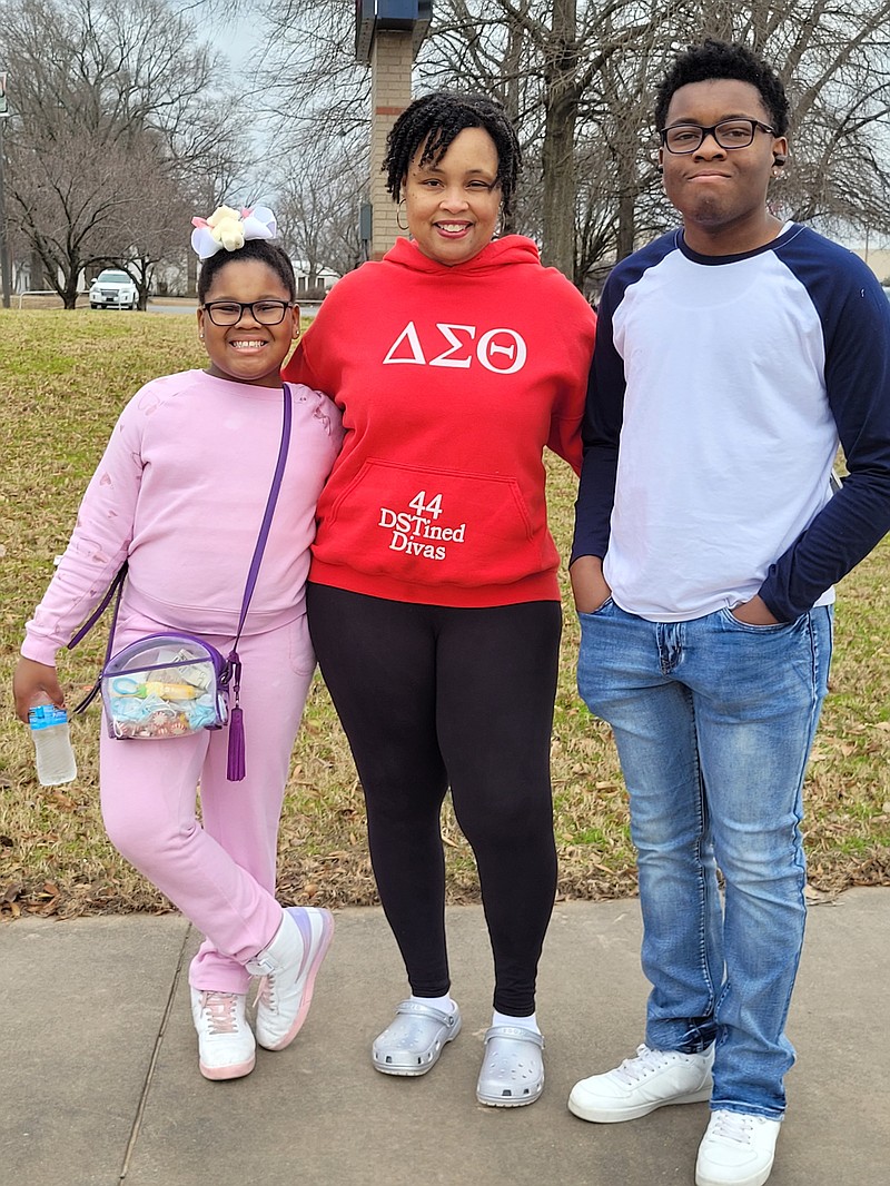 Melanie Madkin (center) enjoys the annual Martin Luther King Jr. parade with her children Cali and Casey on Monday. (Special to The Commercial/Kim Jones Sneed)