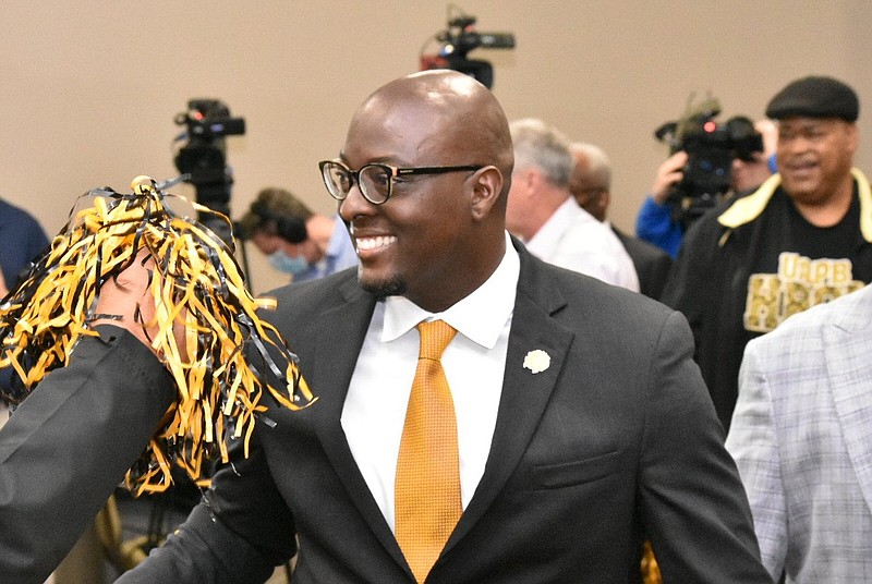 A UAPB fan cheers on Alonzo Hampton as the recently hired head football coach walks into the STEM Conference Center for his introductory press conference Tuesday. (Pine Bluff Commercial/I.C. Murrell)