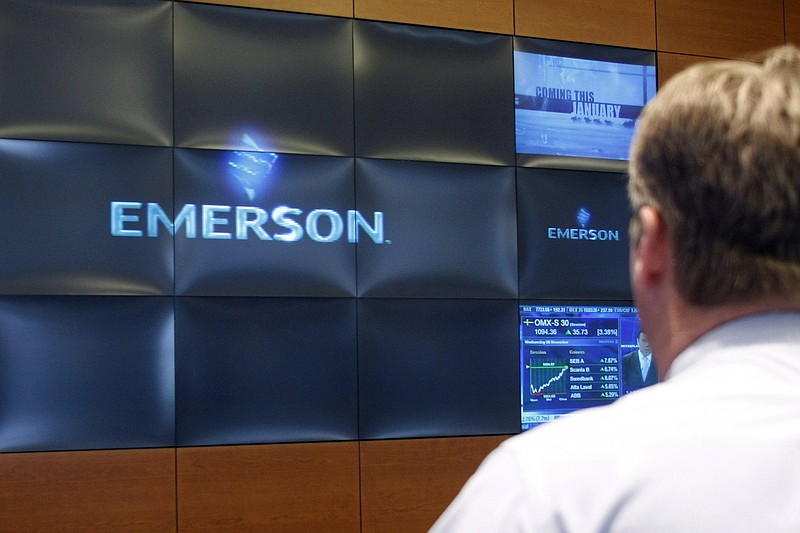 FILE - A visitor views the video wall in the lobby of Emerson Electric's headquarters building in St. Louis, Wednesday, Nov. 28, 2007.  Emerson is making a bid to buy National Instruments, Monday, Jan. 16, 2023 for $7.6 billion. Emerson is offering $53 per share in cash, an enhanced offer that was made in November.  (AP Photo/Tom Gannam)