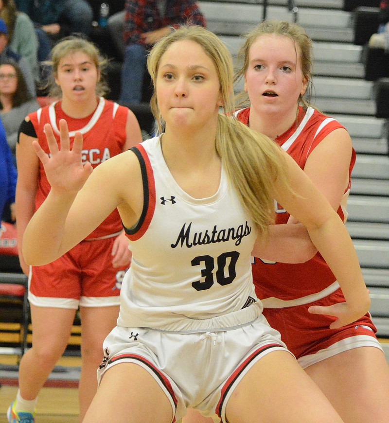 Bennett Horne/McDonald County Press Lady Mustang sophomore Rylee Anderson looks for the ball while posting up in the lane against Seneca during their game on Friday, Jan. 13, at Mustang Arena.