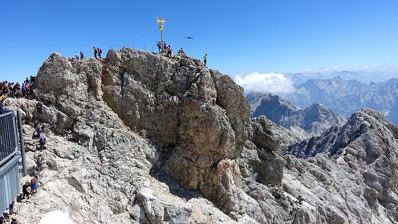A golden cross marks the top of the 9,700-foot Zugspitze, the highest point in Germany. The mountain straddles the border between Germany and Austria, and lifts from both countries whisk visitors to the top. (Rick Steves/TNS)