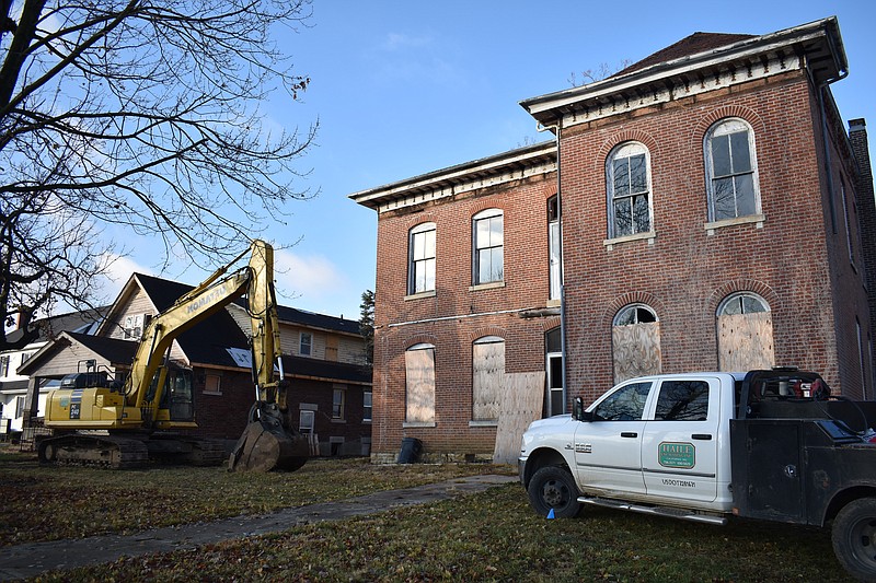 Democrat photo/Garrett Fuller — FILE — Two dilapidated houses are seen Dec. 9, 2022, at 209 S. Oak St., shortly before Gene Haile Excavating Inc., crews started leveling the homes. The Moniteau County Library intends to construct a new library on the lot, which it is currently in the process of closing on.