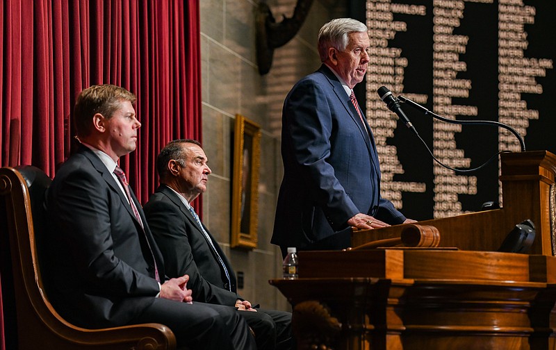 Julie Smith/News Tribune photo: 
Flanked by Speaker of the House Dean Plocher on his right and Lt. Gov. Mike Kehoe on his left, Missouri Gov. Mike Parson delivered the annual State of the State speech Wednesday, Jan. 18, 2023, in the House of Representatives Chamber. The speech was paused numerous times as members of the joint session of legislators stood to applaud.