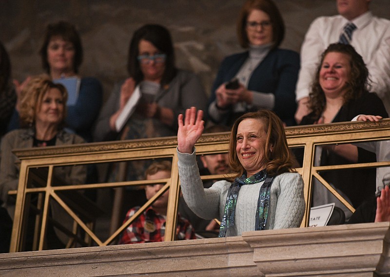 Julie Smith/News Tribune photo:  Sharon Winton stands and waves as attendees applaud after she was recognized by Missouri Gov. Mike Parson during the State of the State speech Wednesday, Jan. 18, 2023. Winton is director of Discovery Place Day Care in Jefferson City.