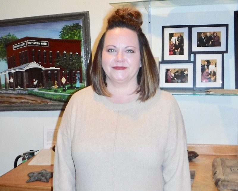 Westside Eagle Observer/Susan Holland
Beth Johnson poses among some of the exhibits in the Gravette Historical Museum. Johnson, who has been hired as the museum's new curator, is a Gravette High School graduate and says she wants to "make history live" for people in the area. She is already planning some upcoming special exhibits and museum events.