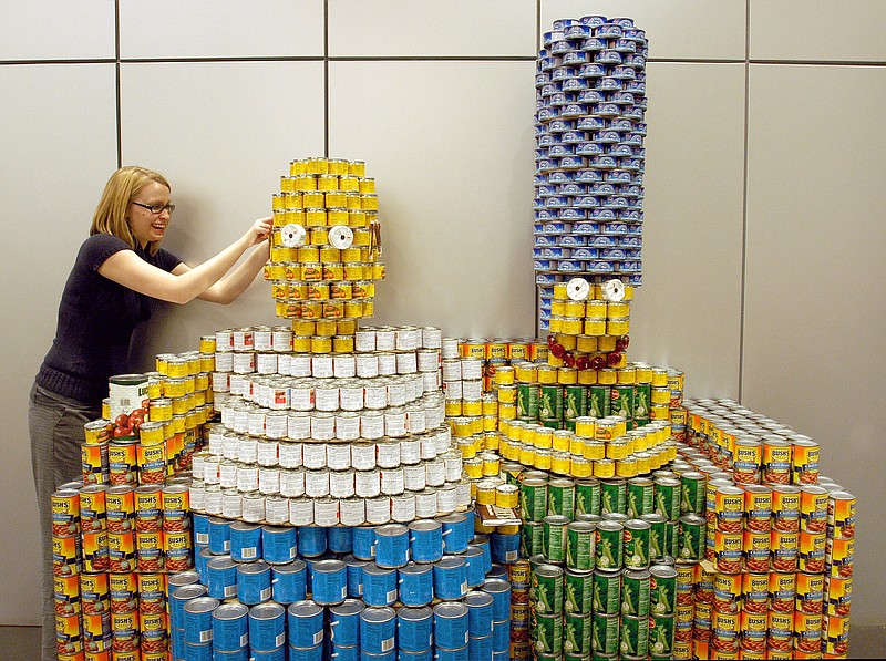 Mandy Breckenridge, with The Wilcox Group Architects, puts finishing touches on Homer Simpson's hair Jan. 16, 2008, during an annual CANstruction event held at the Clinton Presidential Library, to benefit the Arkansas Foodbank Network.  (Democrat-Gazette file photo)