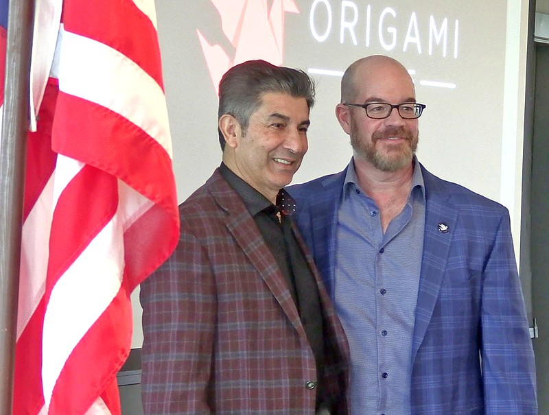 Matt Bell, right, has his photo taken with Saddiq Mir following the presentation on Origami Sake at the Rotary Club of Hot Springs National Park meeting. – Photo by Courtney Edwards of The Sentinel-Record