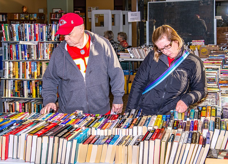 Andrew and Claudia Barnes check out the selection at the Missour River Regional Library Book Sale Saturday.  (Ken Barnes/News Tribune)