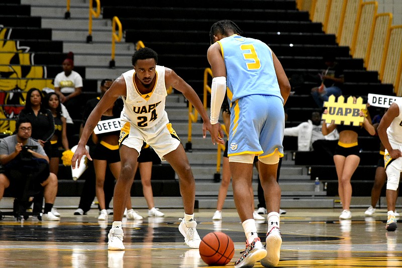 A.C. Curry of UAPB defends P.J. Byrd of Southern in the second half Saturday at H.O. Clemmons Arena. (Pine Bluff Commercial/I.C. Murrell)