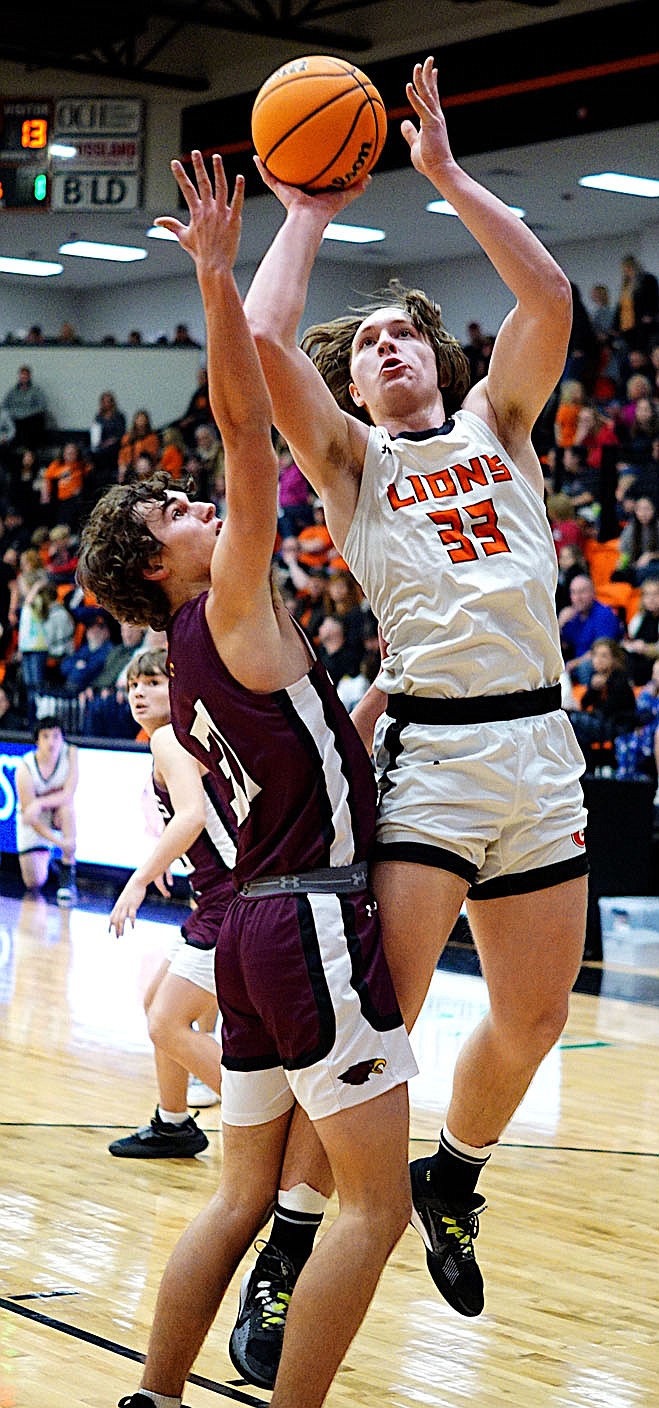 Westside Eagle Observer/Randy Moll
Gravette sophomore Kais Patton shoots over a Huntsville player in the Lions' Den on Friday night.