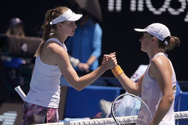 Elena Rybakina, left, of Kazakhstan, left, is congratulated by Iga Swiatek of Poland after their fourth round match at the Australian Open tennis championship in Melbourne, Australia, Sunday, Jan. 22, 2023. (AP Photo/Mark Baker)