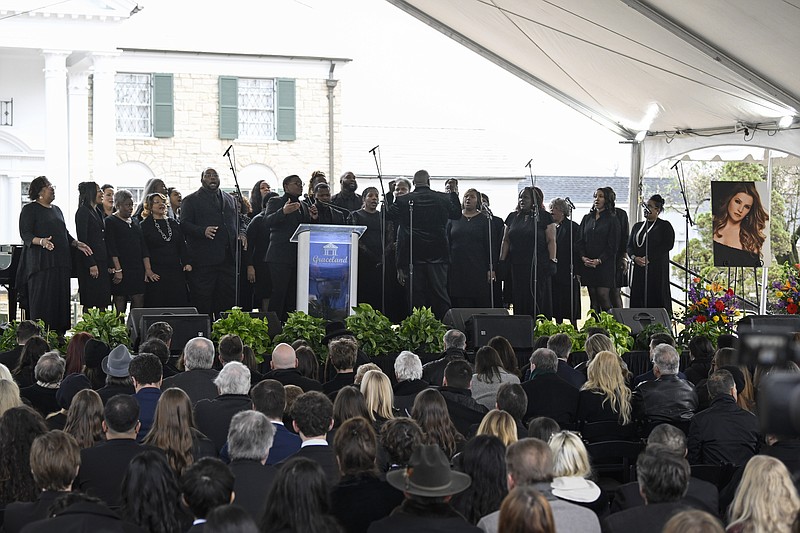Jason Clark and the Tennessee Mass Choir sing during a memorial service for Lisa Marie Presley at Graceland Sunday, Jan. 22, 2023, in Memphis, Tenn. She died Jan. 12 after being hospitalized for a medical emergency and was buried on the property next to her son Benjamin Keough, and near her father Elvis Presley and his two parents. (AP Photo/John Amis)