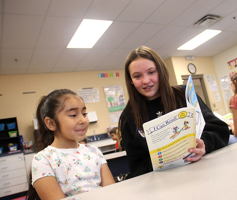 Lynn Kutter/Enterprise-Leader
Brynlee Caplena, an eighth grader at Farmington Junior High, reads the book, Pete the Cat Snow Daze by James Dean to Izza Sosa, a kindergarten student at Folsom Elementary School in Farmington. Eighth graders on Friday bused to the two elementary schools to read the book to all kindergarten students, complete a craft and finish up with hot chocolate. This is the first time the students have been able to return to this annual tradition since the covid pandemic in 2020. Each kindergartener was given the Pete the Cat book to take home.