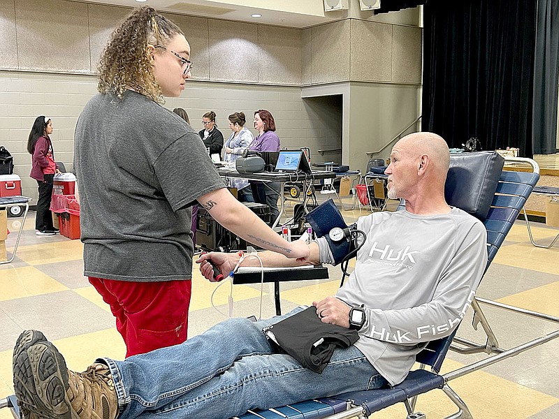 Lynn Kutter/Enterprise-Leader
Mark Myers, fire chief with West Fork Fire Department, donates blood during the Boots and Badges blood drive sponsored by Prairie Grove fire and police departments with the Community Blood Center of the Ozarks. Kyleigh Jackson with the center prepares Myers during the drive held Jan. 16 at Prairie Grove High School.