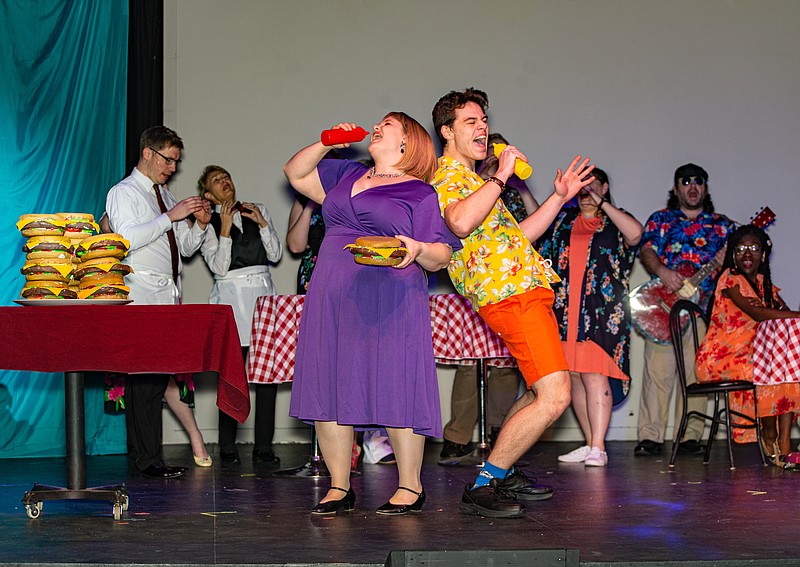 "Tammy" played by Natalie Bessette and "Brick" played by Joe Collins rock the house with "Cheeseburger in Paradise" in CCP's production of "Escape to Margaritaville."  (Ken Barnes/News Tribune)