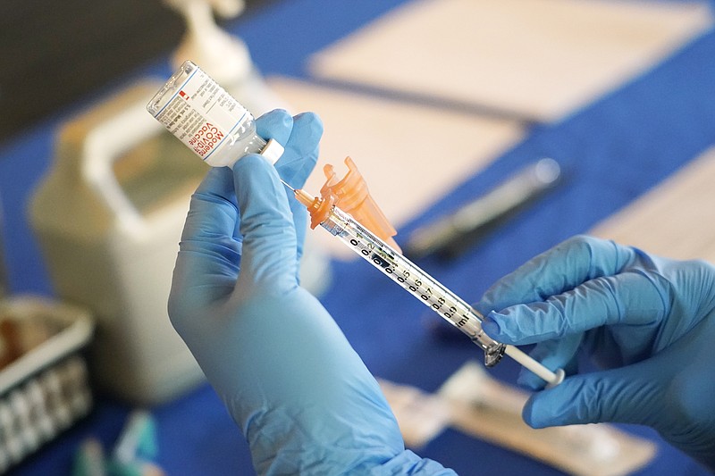 FILE - A nurse prepares a syringe of a COVID-19 vaccine at an inoculation station in Jackson, Miss., July 19, 2022. U.S. health officials are proposing a simplified approach to COVID-19 vaccinations, which would allow most adults and children to get a once-a-year shot to protect against the mutating virus. The new system unveiled Monday, Jan. 23, 2023 would make COVID-19 inoculations more like the annual flu shot. Americans would no longer have to keep track of how many shots they&#x2019;ve received or how many months it&#x2019;s been since their last booster. (AP Photo/Rogelio V. Solis, File)