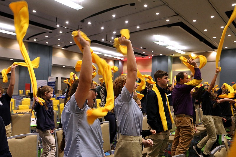 Attendees of the National School Choice Rally blow off steam waving their scarves in the air between speaks on Monday, Jan. 23, 2023, at the Statehouse Convention Center in Little Rock. 
(Arkansas Democrat-Gazette/Thomas Metthe)