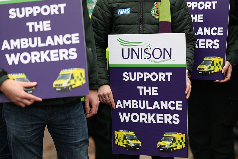 Ambulance service workers hold placards reading 'Support The Ambulance Workers' outside the London Ambulance Service headquarters during a strike in the Waterloo district of London, UK, on Wednesday, Dec. 21, 2022. Ambulance workers are demanding a higher pay rise to cope with the UK's cost of living crisis. MUST CREDIT: Bloomberg photo by Hollie Adams