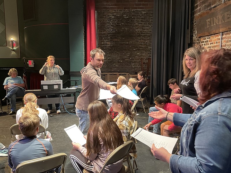 Democrat photo/Kaden Quinn 
Director Andrew Korte hands out music sheets to his cast as they rehearse for the Finke Theatre's latest production of the Disney play "Newsies."