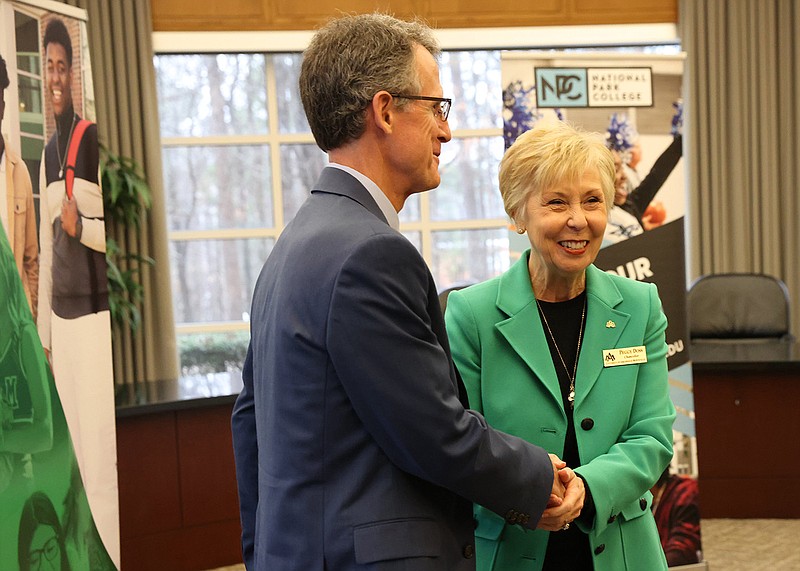 National Park College President John Hogan, left, and UA-Monticello Chancellor Dr. Peggy Doss celebrate after announcing a new partnership between UAM and NPC at a press conference on the Cammack Campus on Tuesday, Jan. 24, 2023. (Arkansas Democrat-Gazette/Colin murphey)