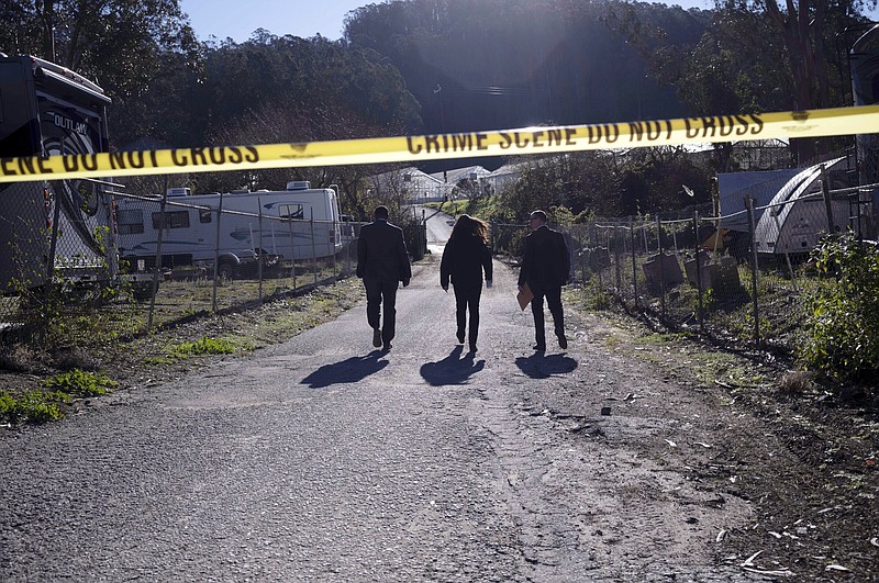 FBI officials walk towards from the crime scene at Mountain Mushroom Farm, Tuesday, Jan. 24, 2023, after a gunman killed several people at two agricultural businesses in Half Moon Bay, Calif.  Officers arrested a suspect in Monday’s shootings, 67-year-old Chunli Zhao, after they found him in his car in the parking lot of a sheriff’s substation, San Mateo County Sheriff Christina Corpus said.  (AP Photo/Aaron Kehoe)