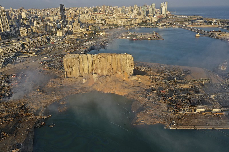 FILE - A drone picture shows the scene of an explosion that hit the seaport of Beirut, on Aug. 5, 2020. Lebanon&#x2019;s top prosecutor Wednesday Jan. 25, 2023 ordered all suspects detained in the deadly 2020 port blast released, a lawyer for two detainees and judicial officials said. (AP Photo/Hussein Malla, File)