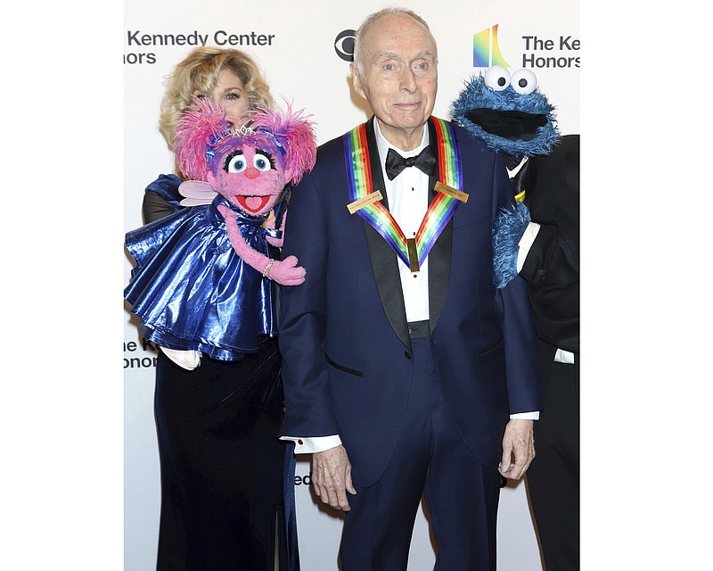 FILE - Honoree Lloyd Morrisett appears with muppet characters at the 42nd Annual Kennedy Center Honors at The Kennedy Center, Sunday, Dec. 8, 2019, in Washington. Morrisett, the co-creator of the beloved children's education TV series “Sesame Street,” which uses empathy and fuzzy monsters like Abby Cadabby, Elmo and Cookie Monster to charm and teach generations around the world, has died. He was 93. Morrisett’s death was announced Tuesday by Sesame Workshop, the nonprofit he helped establish under the name the Children’s Television Workshop. (Photo by Greg Allen/Invision/AP, File)