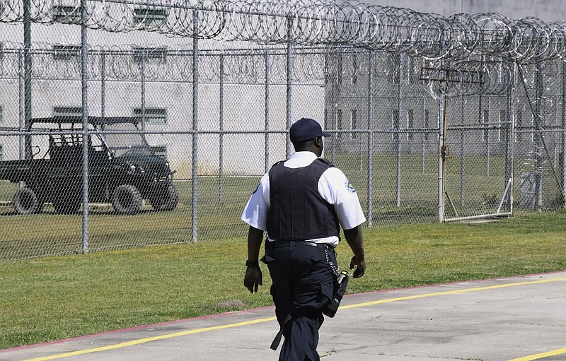 FILE - Prison staff work at Lee Correctional Institution, in Bishopville, S.C.. April 10, 2019. Top state prosecutors are urging Congress to pass legislation allowing state prisons to jam the signals of cellphones smuggled to inmates behind bars. The 22 attorneys general say Wednesday in a letter to House Speaker Kevin McCarthy and Senate Majority Leader Chuck Schumer that the devices allow prisoners to plot violence and carry out crimes.   (AP Photo/Meg Kinnard, File)