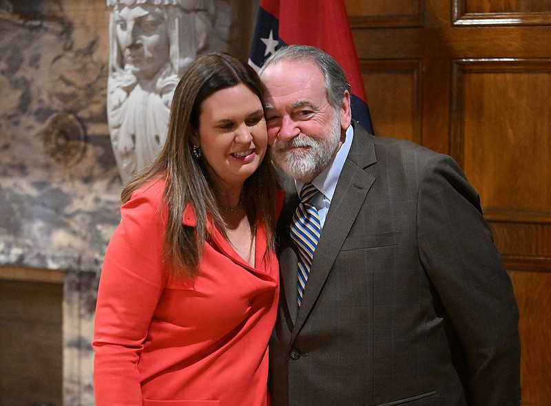 Gov. Sarah Huckabee Sanders hugs her father, former Gov. Mike Huckabee, during a press conference Wednesday, Jan. 25, 2023 in the Governor’s Conference Room, where her father’s gubernatorial portrait will be moved to, at the state Capitol.
(Arkansas Democrat-Gazette/Staci Vandagriff)