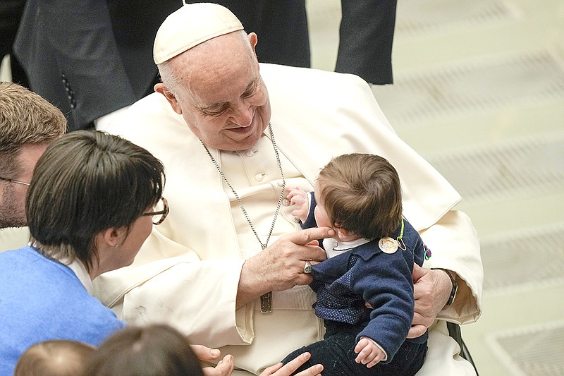 Pope Francis reacts with a child during his weekly general audience in the Pope Paul VI hall at the Vatican, Wednesday, Jan. 25, 2023. (AP Photo/Andrew Medichini)