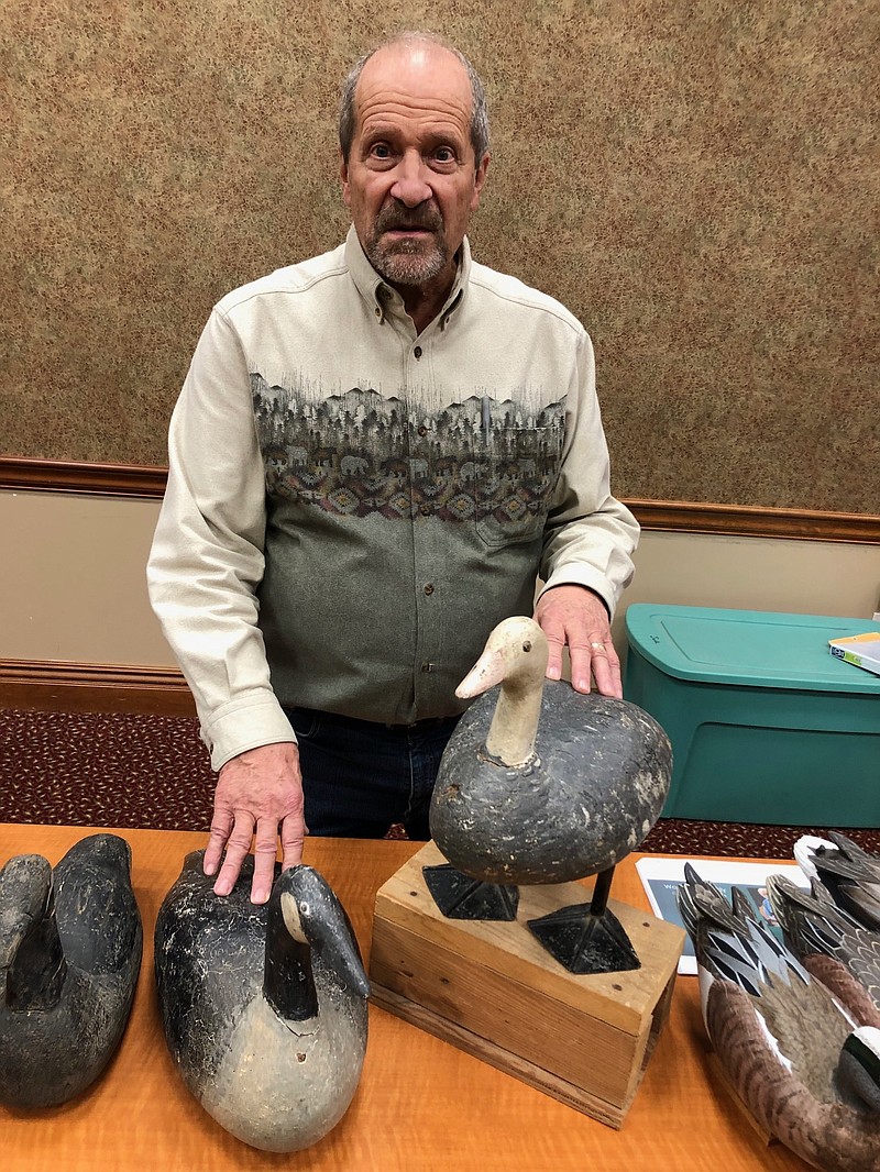 Joe Gamm/News Tribune photo: 
Greg Renner, of Columbia, points out two vintage goose decoys made in Kansas City. On the left is a Canada goose, and on the right is a blue morph snow goose. The blue morph was made to stand up. It included a metal spike that could be driven into ice or frozen ground.
