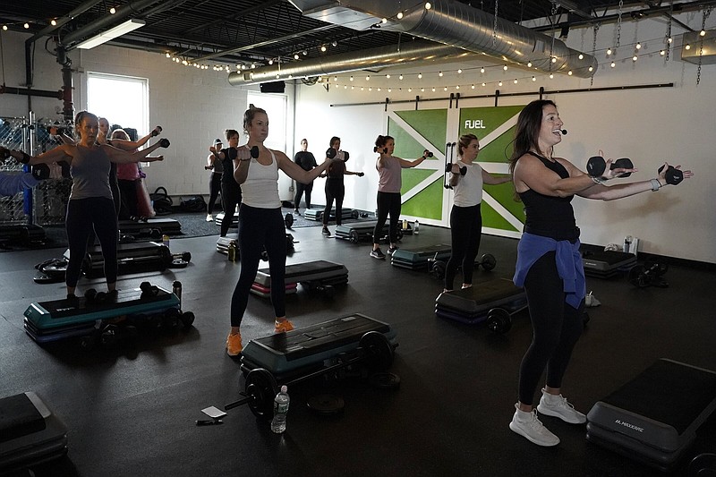 Instructor Jessie Reardon, right, leads a barbell class at Fuel Training Studio, Thursday, Jan. 19, 2023, in Newburyport, Mass. Gyms and fitness studios were among the hardest hit businesses during the pandemic. But for gyms who made it through the worst, signs of stability are afoot. (AP Photo/Mary Schwalm)