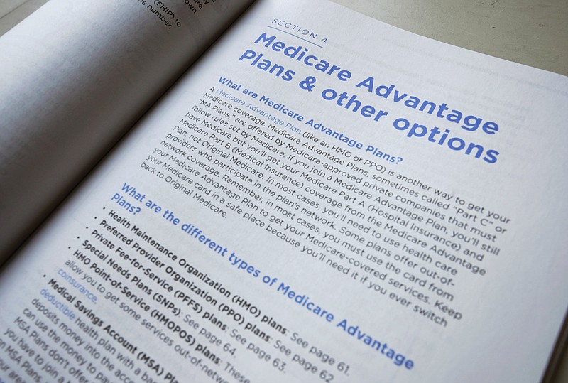 FILE - This Nov. 8, 2018 file photo shows a page from the 2019 U.S. Medicare Handbook in Washington.  In 2022, 48% of Medicare beneficiaries were enrolled in Medicare Advantage plans instead of original Medicare, and experts predict the number will be higher in 2023. Medicare Advantage plans are offered by private insurers and bundle Medicare benefits in a way many people find appealing — but they also limit care to network providers, often require preapproval to see specialists and can saddle beneficiaries with high out-of-pocket costs for serious conditions.  (AP Photo/Pablo Martinez Monsivais, File)