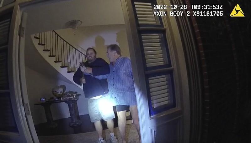 In this image taken from San Francisco Police Department body-camera video, the husband of former U.S. House Speaker Nancy Pelosi, Paul Pelosi, right, fights for control of a hammer with his assailant during a brutal attack in the couple's San Francisco home on Oct. 28, 2022. The body-camera footage shows the suspect David DePape wrest the tool from the 82-year-old Pelosi and lunge toward him the hammer over his head. The blow to Pelosi occurs out of view and the officers &#x2014; one of them cursing &#x2014; rush into the house and jump on DePape. (San Francisco Police Department via AP)