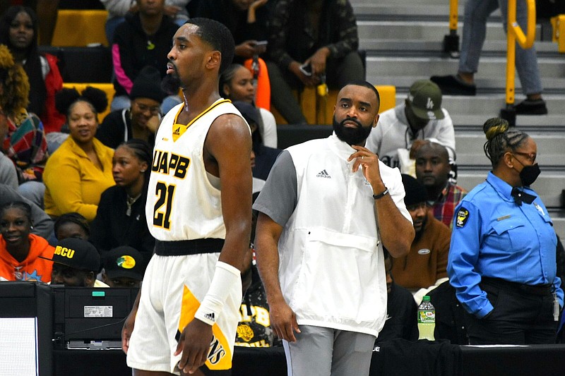 UAPB Coach Solomon Bozeman sends Shaun Doss back on the court during the Jan. 23 home game against Grambling State. (Pine Bluff Commercial/I.C. Murrell)