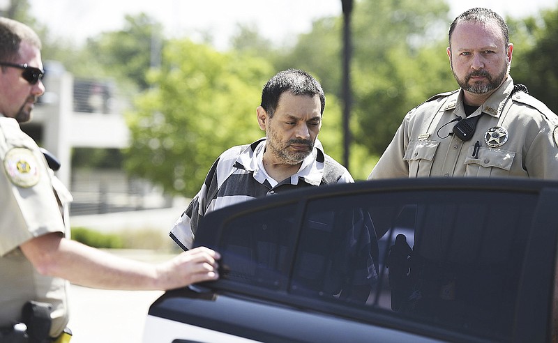 Mauricio Torres is escorted out of the Benton County Courthouse Annex in June 2019 in Bentonville. (File photo/NWA Democrat-Gazette/Charlie Kaijo)