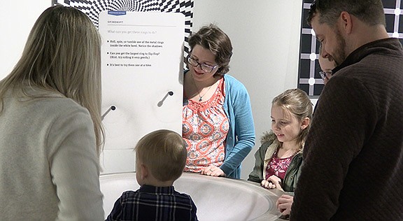 Casey Chandler interacts with a family visiting the museum on Friday. – Photo by Courtney Edwards of The Sentinel-Record