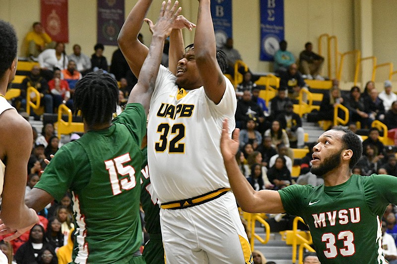 Caleb Stokes of UAPB makes a basket over A.J. Stredic of Mississippi Valley State in the first half Saturday at H.O. Clemmons Arena. Stredic previously played at UAPB. (Pine Bluff Commercial/I.C. Murrell)