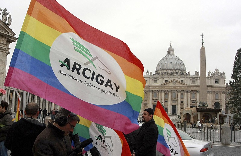 FILE - Italian Arcigay gay rights association activists hold banners and flags during a demonstration in front of The Vatican, in this Tuesday, Jan. 13, 2009 file photo. In an interview with The Associated Press at The Vatican, Tuesday, Jan. 24, 2023, Pope Francis acknowledged that Catholic bishops in some parts of the world support laws that criminalize homosexuality or discriminate against the LGBTQ community, and he himself referred to homosexuality in terms of "sin." But he attributed attitudes to cultural backgrounds and said bishops in particular need to undergo a process of change to recognize the dignity of everyone. (AP Photo/Sandro Pace, file)